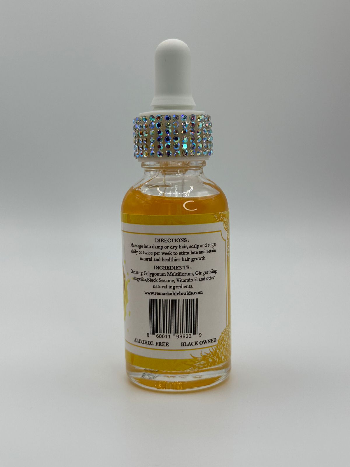 Bottle of liquid with a dropper on a gray background