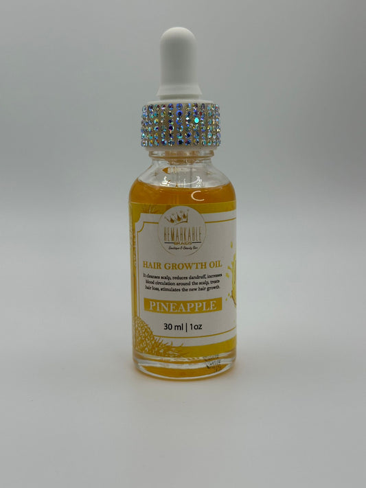 Bottle of remarkable braids pineapple hair growth oil with a dropper on a gray background