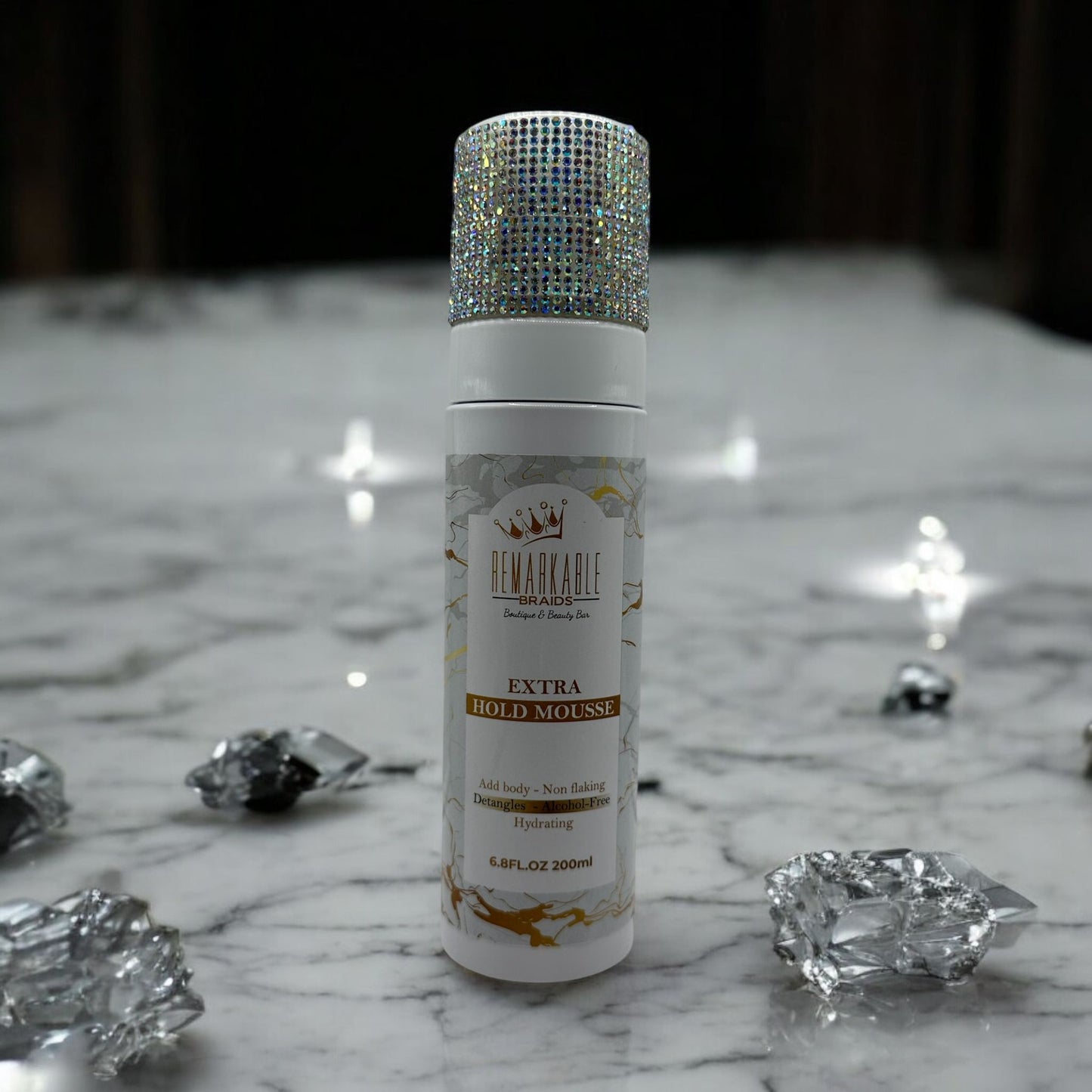 Remarkable Extra Hold Hair Mousse bottle with decorative cap on a marble surface with crystals