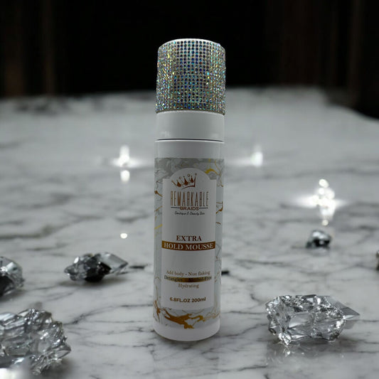 Remarkable Extra Hold Hair Mousse bottle with decorative cap on a marble surface with crystals